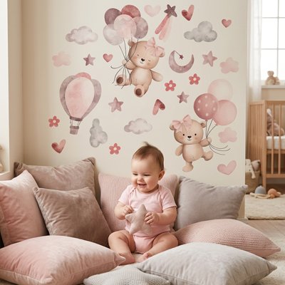 Bébé assis entouré oreillers, heureux dans le magnifique décor crée par stickers muraux enfant univers douillet