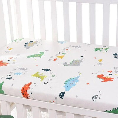 Drap housse lit bébé douceur plus variante dinosaures colorés