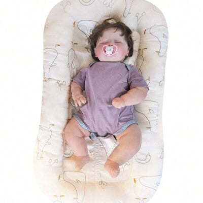 Nid d'ange portable Doux Rêves : variante à motif d'ours polaires beige, bébé endormi avec sucette, pour un confort optimal