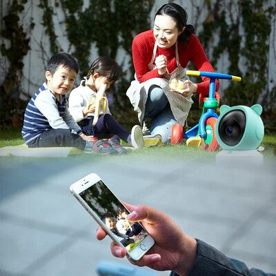 Parent surveillant à distance sa famille grâce application caméra bébé vision HD installée sur téléphone